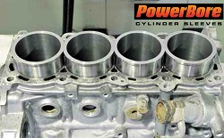 Installing Cylinder Sleeves - Picture of an engine block receiving new cylinder sleeves.